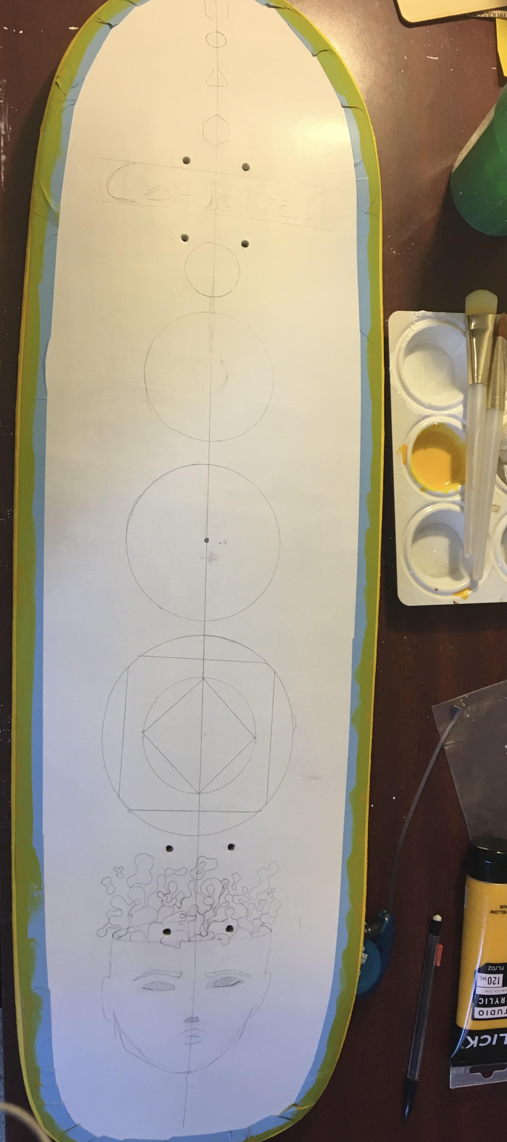 white paint base with sketch lines of shapes layout ideas and paint tape with yellow border